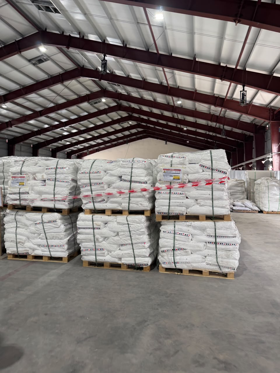 Palletised PON NPG bags stored in a warehouse.